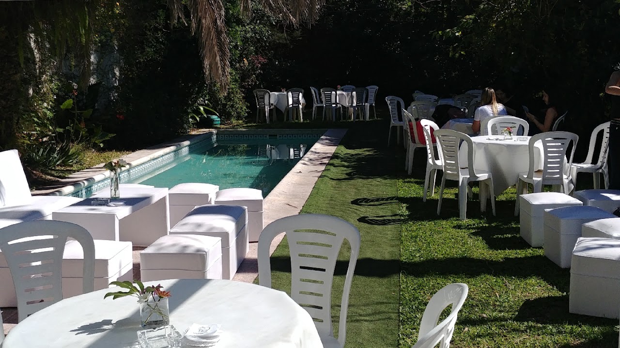 Argentine traditional gourmet asado and catering spread at outdoor event, wood-fired barbecue grill with fine cuts, gourmet salads and rustic wooden presentation boards, festive party catering setup
